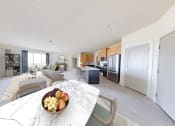 Thumbnail 17 of 22 - a living room with a table with a bowl of fruit
