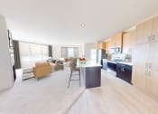 Thumbnail 11 of 22 - a kitchen and living room with a table and chairs