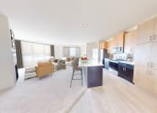 Thumbnail 24 of 64 - a kitchen and living room with a table and chairs