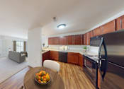 Thumbnail 44 of 65 - A modern kitchen with a bowl of fruit on the table.