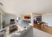 Thumbnail 45 of 65 - A modern living room with a grey sofa and a wooden coffee table.