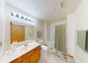 Thumbnail 37 of 65 - A bathroom with a white countertop and a wooden vanity.