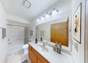 Thumbnail 42 of 53 - A bathroom with a white counter top and a white sink.