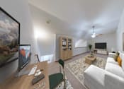 Thumbnail 6 of 26 - A living room with a white couch and a painting on the wall.