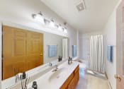 Thumbnail 7 of 26 - A bathroom with a sink, mirror, and towel rack.