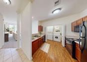 Thumbnail 58 of 59 - A kitchen with wooden floors and white appliances.
