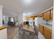 Thumbnail 4 of 42 - A kitchen with a table and chairs in the middle of the room.