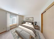 Thumbnail 5 of 42 - A bedroom with a large bed and a window with curtains.