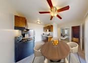 Thumbnail 5 of 37 - A modern kitchen with a wooden table and chairs.