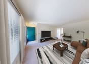 Thumbnail 2 of 37 - A living room with a brown couch and a television.