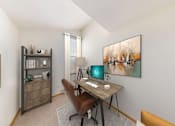 Thumbnail 11 of 12 - A room with a desk, chair, and bookshelf.