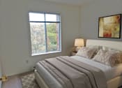 Thumbnail 24 of 32 - a bedroom with a large bed and a window