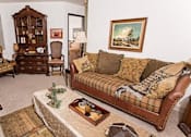 Thumbnail 13 of 16 - a living room with a couch and a chair