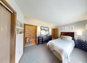 Thumbnail 6 of 50 - A bedroom with a large bed and a window with curtains.