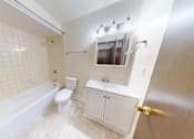 Thumbnail 31 of 32 - a white bathroom with a tub and a sink and a toilet