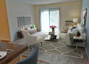 Thumbnail 26 of 32 - a living room with white furniture and a large window