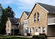 Thumbnail 5 of 28 - the front of a brick building with white doors and windows