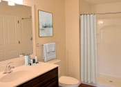 Thumbnail 8 of 28 - a bathroom with a shower and a sink and a toilet
