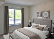 Thumbnail 6 of 28 - a bedroom with a large bed and a window