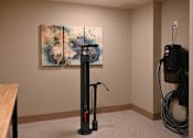 Thumbnail 18 of 25 - a room with a vacuum cleaner and a painting on the wall