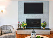 Thumbnail 18 of 21 - a living room with a fireplace and a flat screen tv on the wall