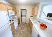 Thumbnail 8 of 21 - a kitchen with white appliances and wooden cabinets