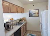 Thumbnail 7 of 14 - a kitchen with a sink and a refrigerator