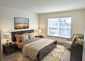 Thumbnail 8 of 14 - a bedroom with a bed and a window