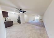 Thumbnail 22 of 32 - an empty living room with a ceiling fan