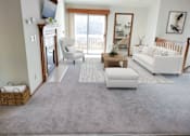 Thumbnail 4 of 28 - a living room with white furniture and a rug
