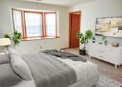 Thumbnail 2 of 28 - a bedroom with a bed and a large window
