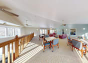 Thumbnail 24 of 28 - A sunny day in a spacious room with a long table and chairs.