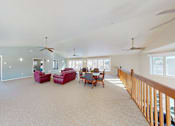 Thumbnail 23 of 28 - A spacious living room with a dining table and chairs.