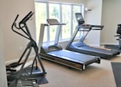 Thumbnail 26 of 28 - two treadmills and other exercise equipment in an indoor gym