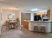 Thumbnail 13 of 28 - a kitchen and dining room with a bar and a table