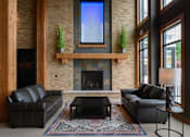 Thumbnail 17 of 53 - a living room with leather couches and a fireplace