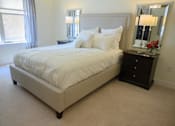 Thumbnail 11 of 53 - a bedroom with a bed and a dresser
