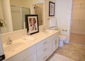Thumbnail 10 of 53 - a bathroom with two sinks and a toilet and a mirror