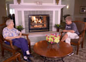 Thumbnail 13 of 14 - two people sitting around a table in front of a fireplace