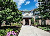 Thumbnail 1 of 14 - a sidewalk in front of a building with a clock on the front