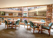 Thumbnail 1 of 12 - a dining room with tables and chairs and a large window
