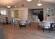 Thumbnail 6 of 26 - A dining room with a table and chairs.