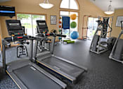 Thumbnail 7 of 26 - A gym with treadmills, exercise bikes, and other equipment.