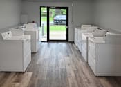 Thumbnail 20 of 26 - A row of white appliances are lined up in a room.