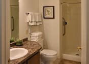 Thumbnail 41 of 43 - A bathroom with a sink, toilet, and shower.