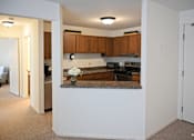 Thumbnail 43 of 43 - A kitchen with brown cabinets and a marble countertop.