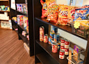Thumbnail 48 of 49 - A shelf of canned goods and snacks.