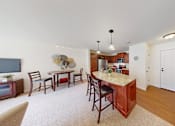Thumbnail 29 of 36 - A kitchen with a dining table and chairs.