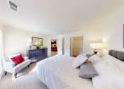 Thumbnail 31 of 36 - A bedroom with a large bed and a couch.