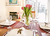 Thumbnail 10 of 21 - a table with a vase of flowers on top of it